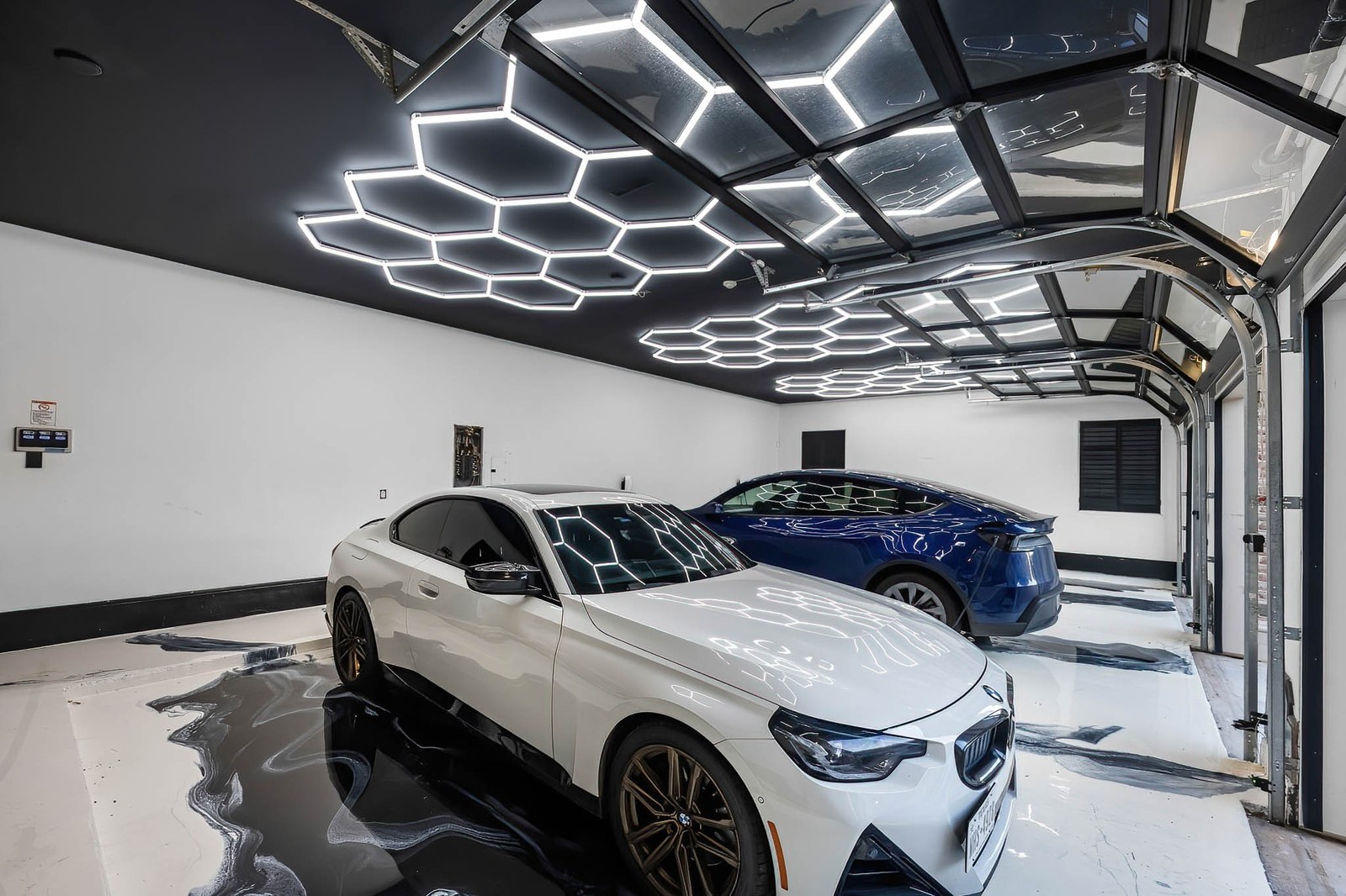 Showroom garage with hexagon LED ceiling lights and epoxy floor