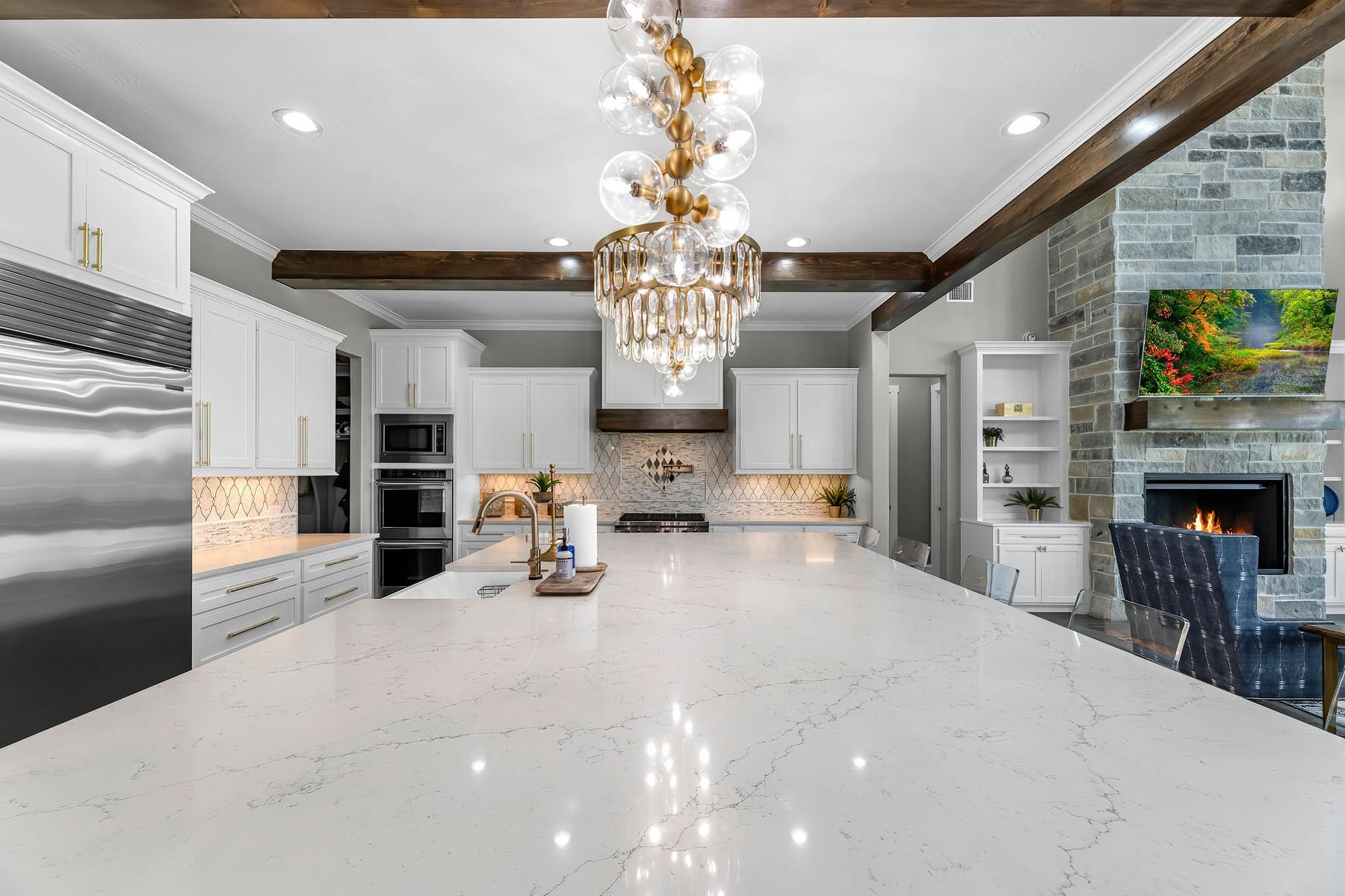 Kitchen with a marble island and chandelier