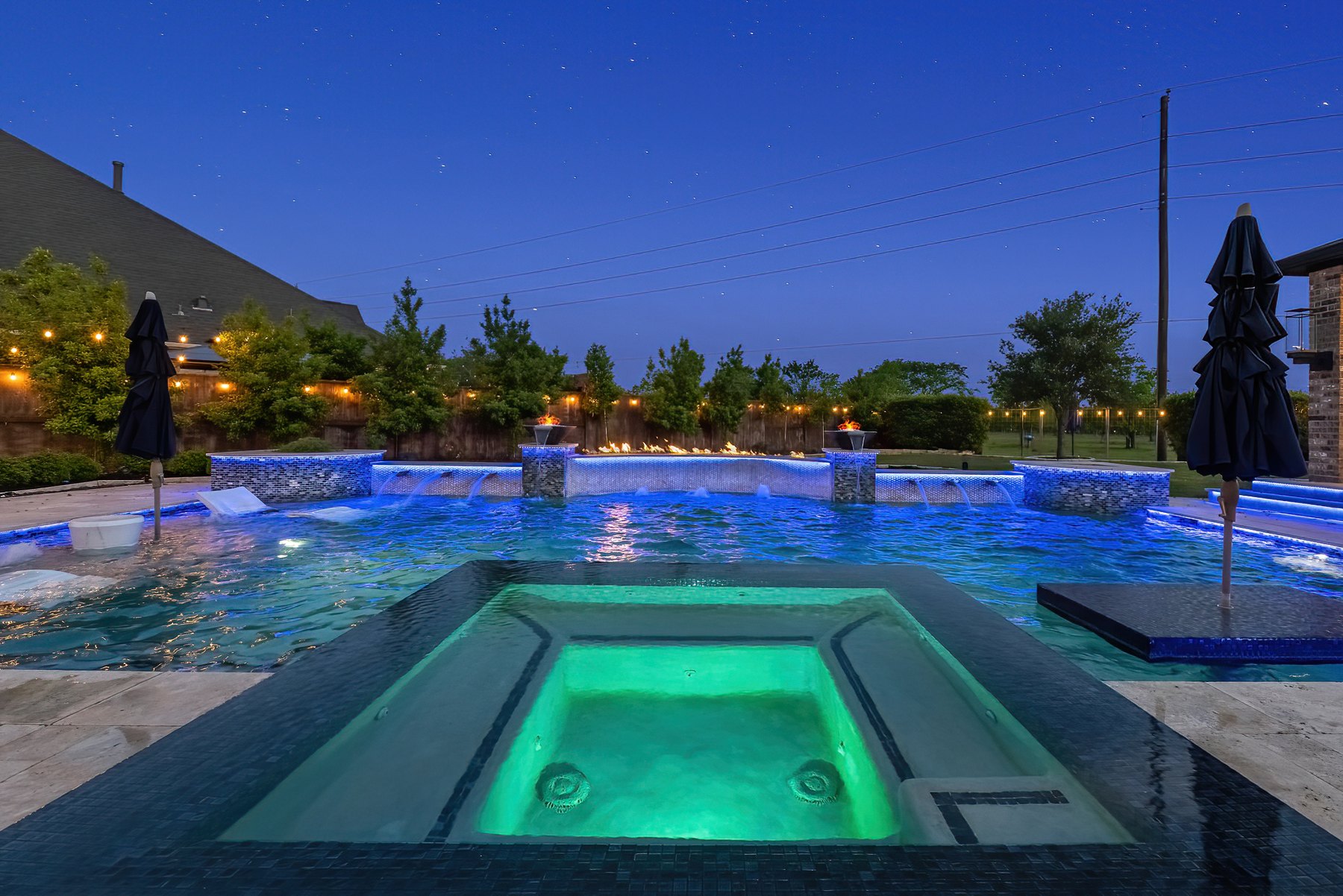 Glowing spa and pool at dusk