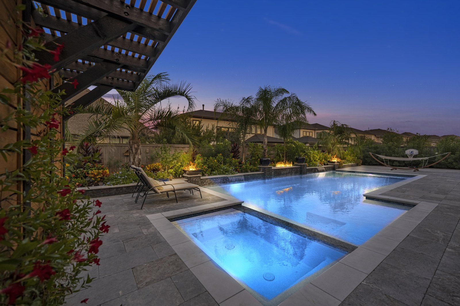 Virtual twilight pool with fire bowls at dusk
